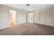 Spacious bedroom featuring neutral walls, carpet, a closet and entry to the ensuite bathroom at 4559 Crescent Rd, Spring Hill, FL 34606