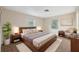 Bright bedroom with two windows, neutral walls, a queen size bed, and modern décor at 4559 Crescent Rd, Spring Hill, FL 34606