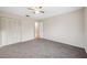 Bedroom featuring a ceiling fan, plush carpeting and a set of folding closet doors at 4559 Crescent Rd, Spring Hill, FL 34606