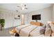 Cozy bedroom with neutral tones, a ceiling fan, a TV and a comfy bed at 4559 Crescent Rd, Spring Hill, FL 34606