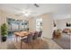 Cozy dining area with a wooden table set for four, tile floors, and a view of the screened-in porch at 4559 Crescent Rd, Spring Hill, FL 34606