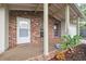 Welcoming front porch with brick accents, decorative plants, and a view of the attached garage at 4559 Crescent Rd, Spring Hill, FL 34606