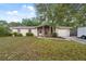 Charming home with a brick facade, attached garage, and lawn at 4559 Crescent Rd, Spring Hill, FL 34606