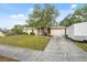 Home showcasing a well-maintained front yard, driveway, and attached garage at 4559 Crescent Rd, Spring Hill, FL 34606