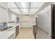 Bright kitchen featuring tile flooring, stainless steel appliances, and a full suite of white cabinets at 4559 Crescent Rd, Spring Hill, FL 34606