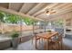 Inviting screened porch with dining table, ceiling fan, and view of the backyard at 4559 Crescent Rd, Spring Hill, FL 34606