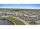 Aerial view showing the community’s buildings, canal, pool, and surrounding neighborhood at 4632 Marine Pkwy # 201, New Port Richey, FL 34652