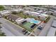 Aerial view showcasing the community pool, clubhouse, and shuffleboard courts at 4632 Marine Pkwy # 201, New Port Richey, FL 34652