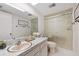 Clean bathroom with updated sink, vanity, and a walk-in shower with glass door at 4632 Marine Pkwy # 201, New Port Richey, FL 34652