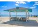 Inviting covered picnic area on a sandy beach, perfect for relaxing and enjoying the ocean view at 4632 Marine Pkwy # 201, New Port Richey, FL 34652