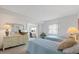 Bright bedroom featuring twin beds, a dresser with a mirror, and a glimpse of a separate office space at 4632 Marine Pkwy # 201, New Port Richey, FL 34652