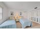 Comfortable bedroom featuring twin beds with blue bedspreads, mirrored closet doors, and a neutral color scheme at 4632 Marine Pkwy # 201, New Port Richey, FL 34652