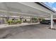 A covered carport with assigned parking and well-maintained landscaping at 4632 Marine Pkwy # 201, New Port Richey, FL 34652