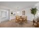 Bright dining area with seating for six, adjacent to a built-in bar and living area at 4632 Marine Pkwy # 201, New Port Richey, FL 34652