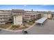 Aerial view of condo building showcasing landscaping and parking at 4632 Marine Pkwy # 201, New Port Richey, FL 34652