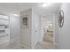 Hallway featuring neutral paint, updated flooring, and easy access to the kitchen and bedroom at 4632 Marine Pkwy # 201, New Port Richey, FL 34652