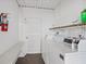 A clean and functional laundry room with washer and dryer units and storage at 4632 Marine Pkwy # 201, New Port Richey, FL 34652