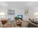 Cozy living room with comfortable seating, a glass coffee table, and beach-themed decor at 4632 Marine Pkwy # 201, New Port Richey, FL 34652