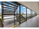 Outdoor stairwell with metal railings providing access to upper level of the community, with covered walkway at 4632 Marine Pkwy # 201, New Port Richey, FL 34652