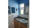 A well-lit bathroom with a gray countertop vanity and a classic design at 4653 Cambridge Ave # 4653, New Port Richey, FL 34652