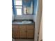A well-lit bathroom with a gray countertop vanity and a classic design at 4653 Cambridge Ave # 4653, New Port Richey, FL 34652