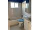 A bathroom featuring white tile, blue trim, and a combined tub and shower at 4653 Cambridge Ave # 4653, New Port Richey, FL 34652
