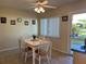 A cozy dining area with a white tile-topped table and natural light from the window at 4653 Cambridge Ave # 4653, New Port Richey, FL 34652