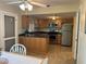 An open kitchen with stainless steel appliances and a breakfast bar island at 4653 Cambridge Ave # 4653, New Port Richey, FL 34652