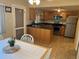 An open kitchen with stainless steel appliances and a breakfast bar island at 4653 Cambridge Ave # 4653, New Port Richey, FL 34652