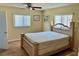 Bedroom with a beautiful wooden frame bed and large windows offering plenty of natural light at 4653 Cambridge Ave # 4653, New Port Richey, FL 34652