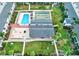 Overhead view of a well-maintained community featuring a pool, shuffleboard court, and landscaped grounds at 5335 Embassy Ave # 5335, New Port Richey, FL 34652