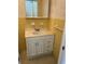 Bathroom featuring bright yellow tiling, vanity with drawers and cabinet, and patterned wallpaper at 5335 Embassy Ave # 5335, New Port Richey, FL 34652