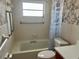 Bathroom featuring a toilet, tub, shower, window, and shower curtain at 5335 Embassy Ave # 5335, New Port Richey, FL 34652