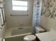 Bathroom with accessibility bars and shower, tiled walls, and a toilet at 5335 Embassy Ave # 5335, New Port Richey, FL 34652