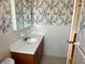 Bathroom with patterned wallpaper, tiled walls, a vanity, and a large mirror at 5335 Embassy Ave # 5335, New Port Richey, FL 34652