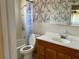 Bathroom with tub and shower, patterned wallpaper, tiled walls, a vanity, and a large mirror at 5335 Embassy Ave # 5335, New Port Richey, FL 34652