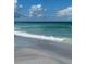 Scenic view of ocean waves meeting the sandy beach on a sunny day with blue skies at 5335 Embassy Ave # 5335, New Port Richey, FL 34652