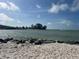 Scenic view of a rocky beach with water and an island in the background at 5335 Embassy Ave # 5335, New Port Richey, FL 34652