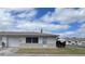 Charming single-story home featuring a well-maintained lawn, attached garage, and neutral color scheme at 5335 Embassy Ave # 5335, New Port Richey, FL 34652