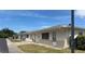 Row of charming single-story homes featuring a well-maintained lawns and neutral color scheme at 5335 Embassy Ave # 5335, New Port Richey, FL 34652