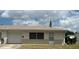 Charming single-story home featuring an attached garage, well-kept lawn, and neutral brick accents at 5335 Embassy Ave # 5335, New Port Richey, FL 34652