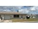 Charming single-story home featuring an attached garage, well-kept lawn, and neutral brick accents at 5335 Embassy Ave # 5335, New Port Richey, FL 34652