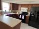 Well-equipped kitchen with ample counter space, modern appliances, and wood cabinets at 5335 Embassy Ave # 5335, New Port Richey, FL 34652