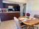 Cozy kitchen with dark wood cabinets and matching black appliances adjacent to eat-in kitchen table at 5335 Embassy Ave # 5335, New Port Richey, FL 34652
