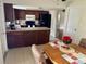 Eat-in kitchen features dark cabinets, neutral counters, and an adjacent breakfast nook at 5335 Embassy Ave # 5335, New Port Richey, FL 34652