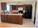 Updated kitchen with modern appliances, dark wood cabinets, and a breakfast bar for extra seating at 5335 Embassy Ave # 5335, New Port Richey, FL 34652