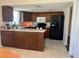 Spacious kitchen with tile floor, dark cabinets, countertops, and appliances at 5335 Embassy Ave # 5335, New Port Richey, FL 34652