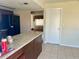 Open kitchen with countertops, dark cabinets, black appliances, and tile flooring at 5335 Embassy Ave # 5335, New Port Richey, FL 34652