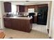 This kitchen boasts lots of cabinets, black appliances and a breakfast bar for convenience at 5335 Embassy Ave # 5335, New Port Richey, FL 34652