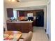 View of kitchen with tile floor, dark cabinets, countertops, and appliances at 5335 Embassy Ave # 5335, New Port Richey, FL 34652